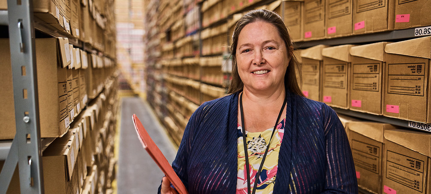 An SGEU member stands in the Provincial Archives.