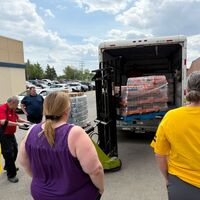 SGEU members watch as a Co-op employee uses a jack to lift a pallet of Gatorade into a truck beside the Rochdale Sherwood Co-op in Regina.