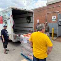 SGEU members watch as a Co-op employee uses a jack to lift a pallet of Gatorade into a truck beside the Rochdale Sherwood Co-op in Regina.