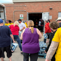 SGEU members and Co-op employees help load cases of water into a truck beside the Rochdale Sherwood Co-op in Regina.