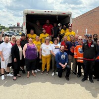 SGEU members and Co-op employees pose in and by the truck of supplies beside the Rochdale Sherwood Co-op in Regina.