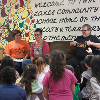 Reading a story and chatting with children at the Twin Lakes Community School